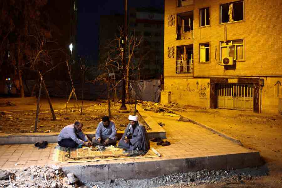 A volunteer team in Tehran that helps restore homes after strikes sits down for iftar during Ramzan last week. (Majid Asgaripour/West Asia News Agency via Reuters)