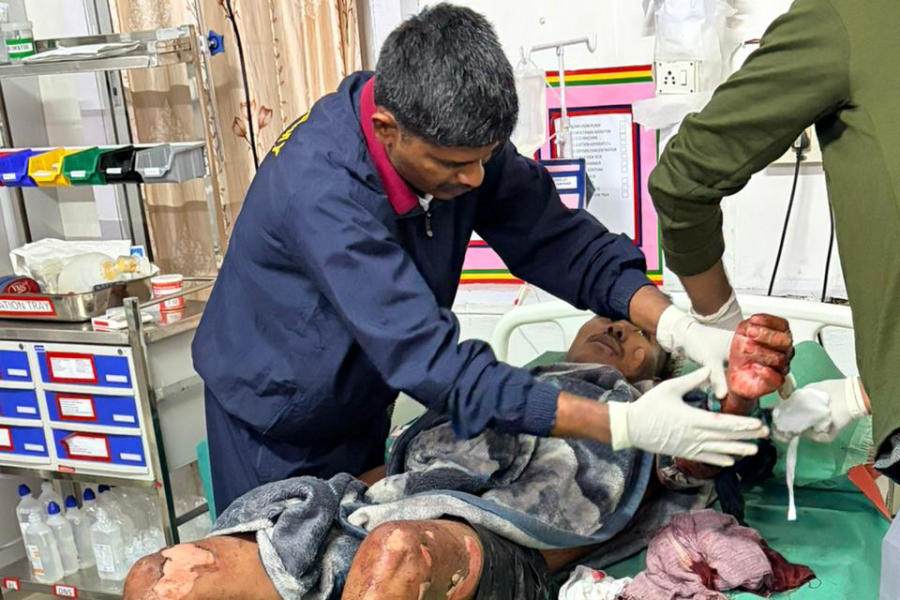 An injured person receives medical treatment at Assam Medical College and Hospital following an alleged attack at a police commando camp, in Tinsukia district of Assam, Sunday, March 22, 2026.