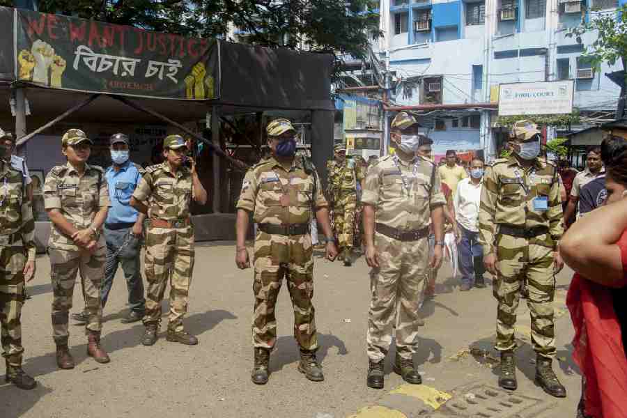 Security personnel stand guard outside RG Kar Medical College during a protest by Akhil Bharatiya Vidyarthi Parishad (ABVP) over the death of a patient’s family member in the hospital lift, in Kolkata, Sunday, March 22, 2026.