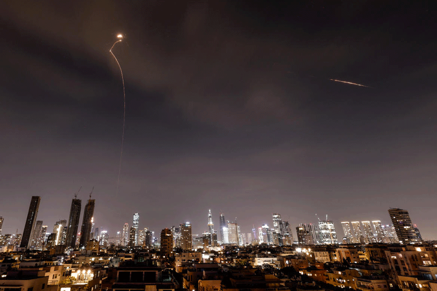 Streaks of light illuminate the sky during an interception attempt amid the U.S.-Israeli conflict with Iran, as seen from Tel Aviv, Israel, March 23, 2026.