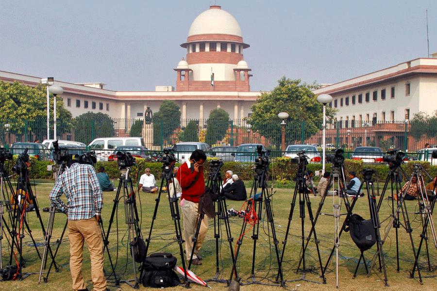Tripods of television crew stand in front of the Indian Supreme Court building in New Delhi