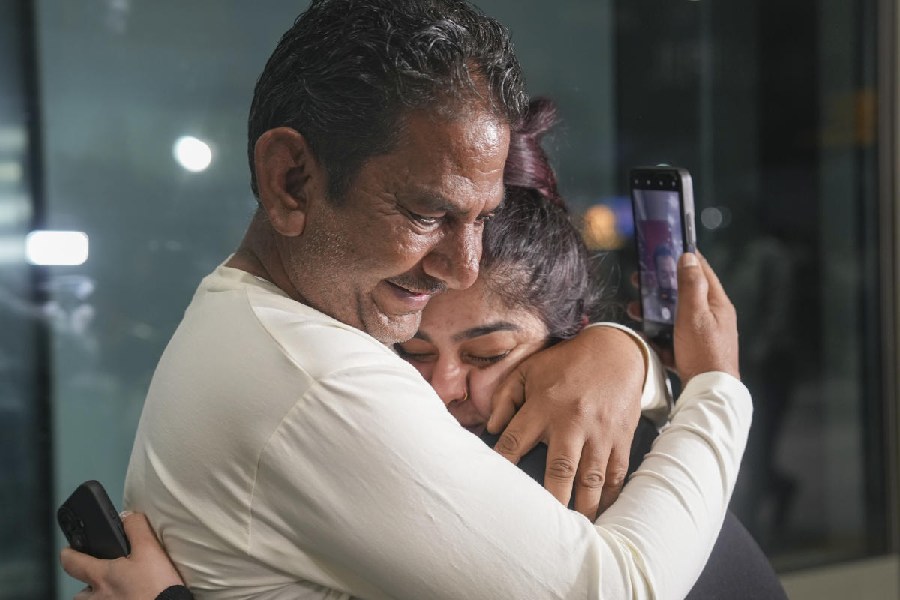 A passenger is embraced by a family member