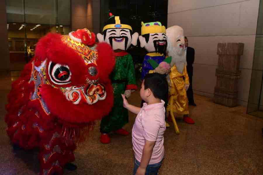A child meets a dragon as the three wise men, Fuk, Luk and Sau, look on