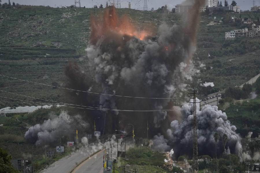 Smoke and flames rise from an Israeli airstrike that hit the Qasmiyeh Bridge near the coastal city of Tyre, Lebanon, Sunday, March 22, 2026.