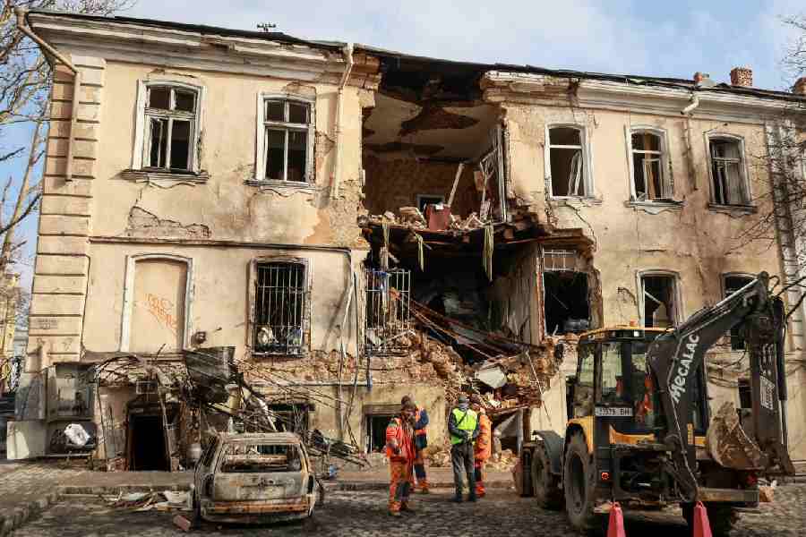 Communal workers clean an area at the site of an apartment building hit by a Russian drone strike, amid Russia\\\'s attack on Ukraine, in Odesa, Ukraine, March 19, 2026.