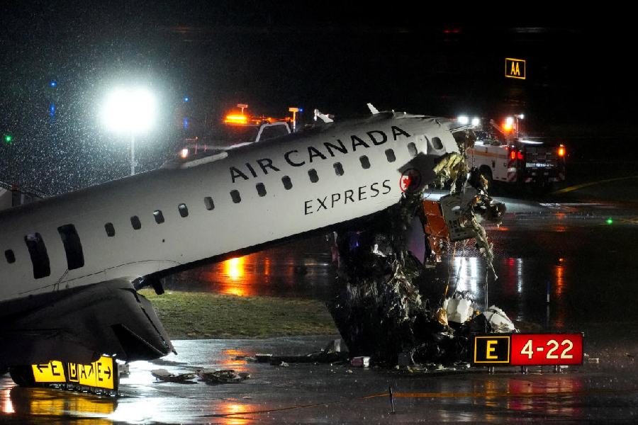 Debris hangs from a damaged Air Canada Express jet