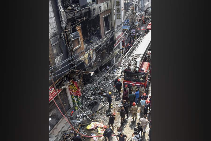 Firefighters at the site after a fire broke out at a multi-storey building in southwest Delhi's Palam area, in New Delhi, Wednesday, March 18, 2026.