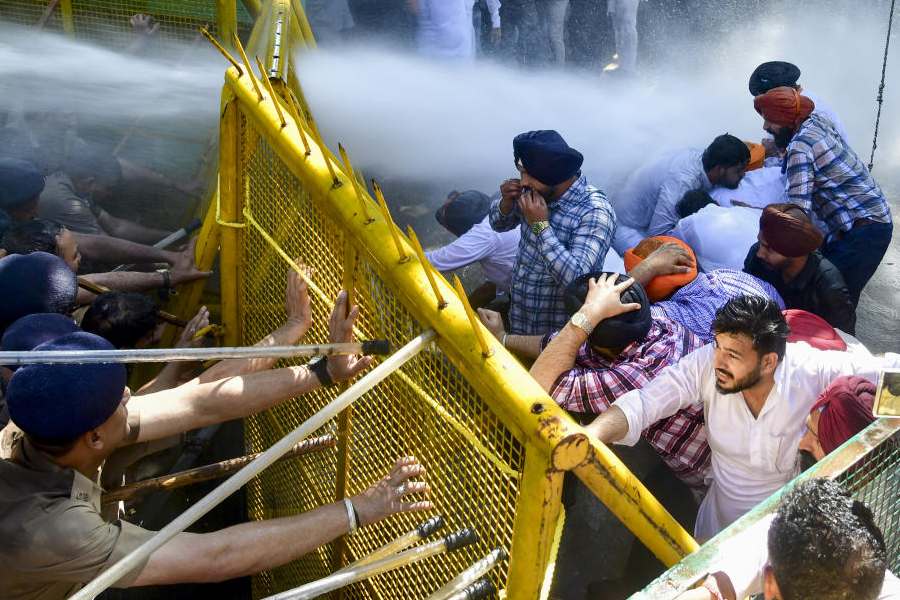 Police use cannons to disperse protesters as they tried to force their way through barricades to 'gherao' Punjab Chief Minister Bhagwant Mann's residence during a joint stir to demand the arrest of former minister Laljit Singh Bhullar, accused of abetting the suicide of a state warehousing corporation official, in Chandigarh, Sunday, March 22, 2026.