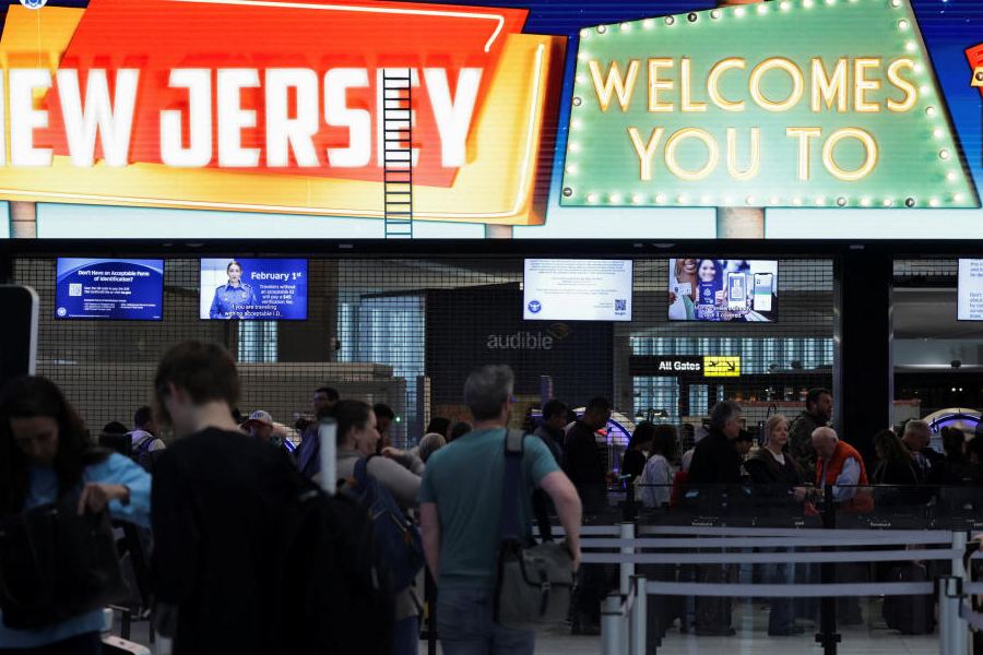 People wait in line to go through security checks, after hundreds of Immigration and Customs Enforcement agents were ordered to deploy to airports to help fill TSA staffing gaps, at Newark Liberty International Airport in Newark, New Jersey, U.S., March 23, 2026.