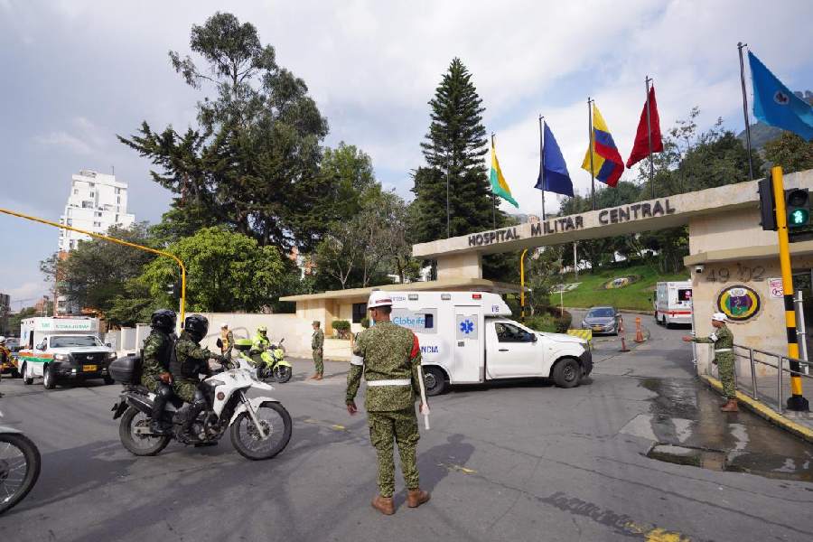 Ambulances carrying people who were injured on a military cargo plane that crashed shortly after takeoff in Puerto Leguizamo arrive at the Military Hospital in Bogota, Colombia.