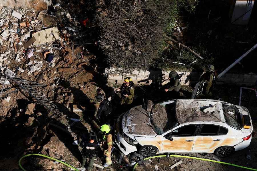 Emergency personnel work at the site following Iranian missile barrages in central Israel