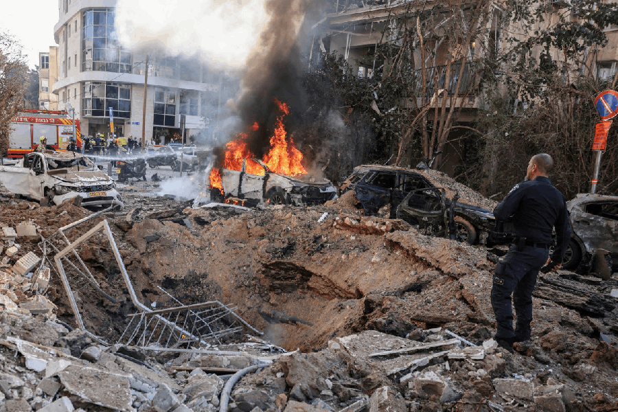 Emergency personnel respond at a site following Iranian missile barrages in central Israel, amid the U.S.-Israel conflict with Iran, in Tel Aviv, Israel, March 24, 2026.