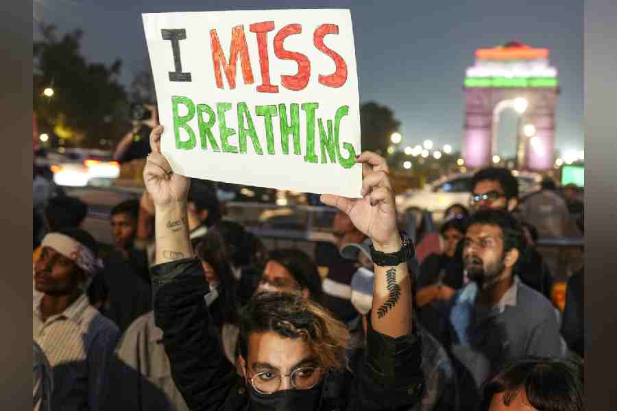 A demonstrator holds a placard during a protest over the deteriorating air quality in the national capital region, in New Delhi, Sunday, Nov. 9, 2025.