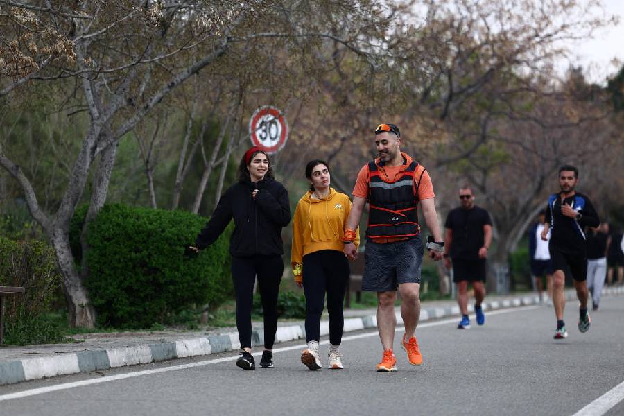 Iranian people walk at Pardisan Park, amid the U.S.-Israeli conflict with Iran, in Tehran, Iran, March 25, 2026.