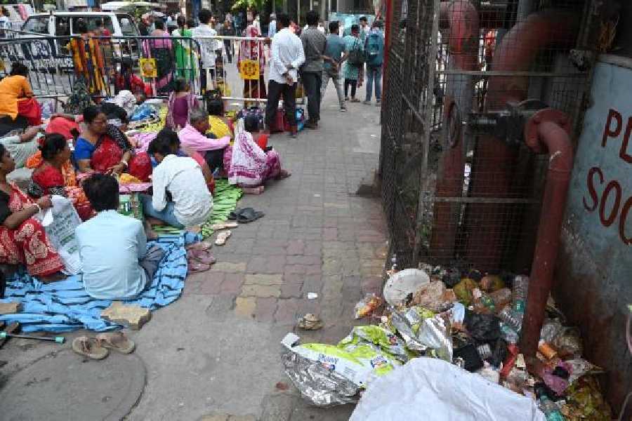 Families of patients waiting near a garbage dump atRG Kar hospital on Tuesday