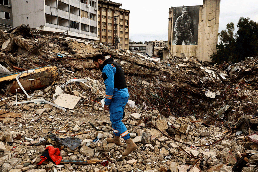 A paramedic walks among the rubble at a site damaged in an Israeli strike, amid escalating hostilities between Israel and Hezbollah, as the U.S.-Israeli conflict with Iran continues, in Nabatieh, Lebanon, March 25, 2026.