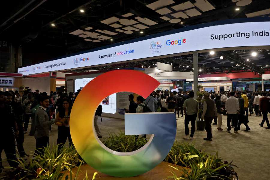 Visitors walk near a logo of Google at Bharat Mandapam, one of the venues for AI Impact Summit, in New Delhi, India, February 17, 2026.