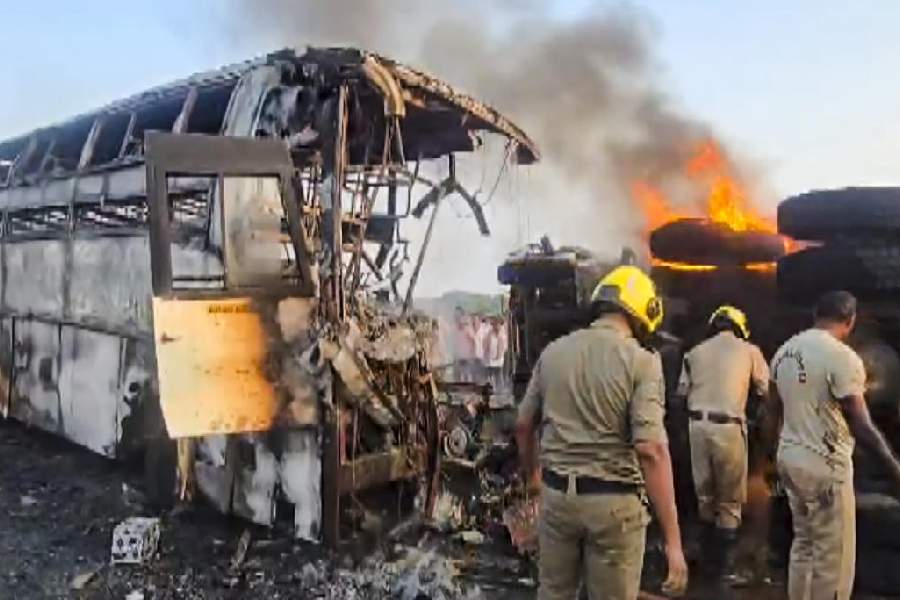 Rescue personnel during an operation after a private bus caught fire, in Rayavaram, Andhra Pradesh, Thursday, March 26, 2026. At least 14 people were killed and 23 injured in the incident.