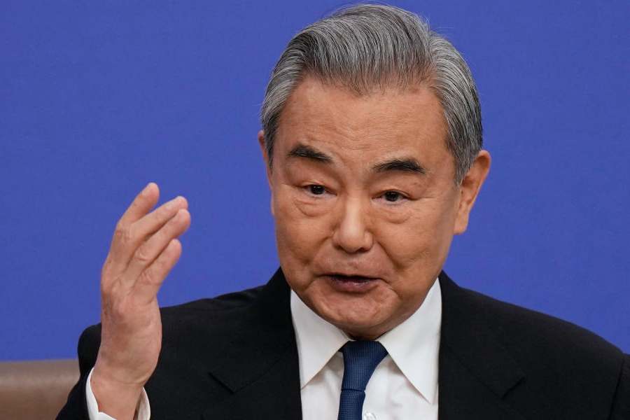 Chinese Foreign Minister Wang Yi speaks during a press conference on the sideline of the National People's Congress (NPC) at the media center, in Beijing, Sunday, March 8, 2026.