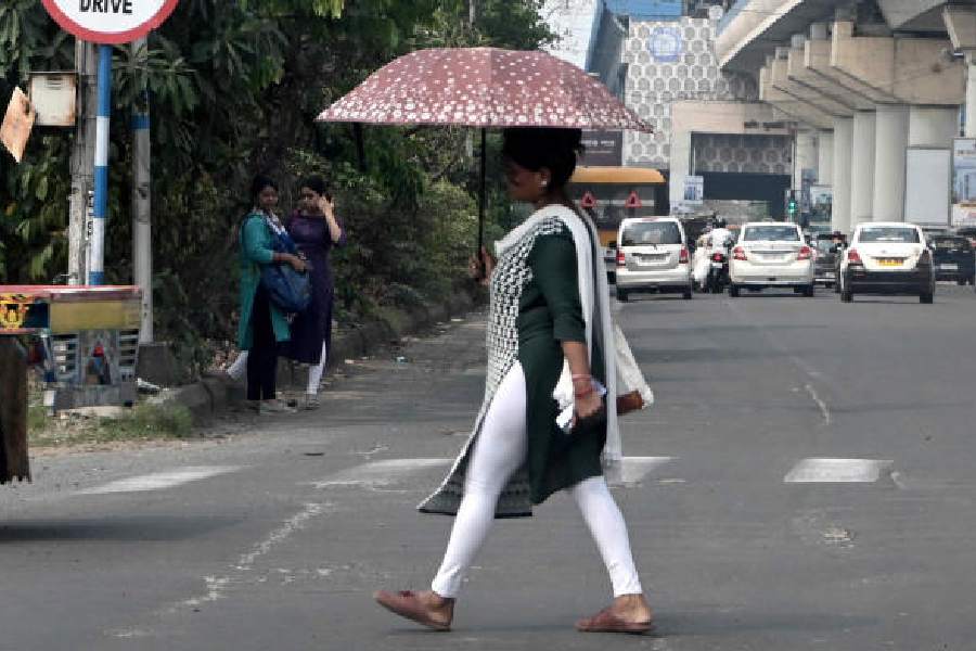 A pedestrian crosses EM Bypass on a sultry Thursday afternoon. The storm was localised and most of Calcutta remained dry