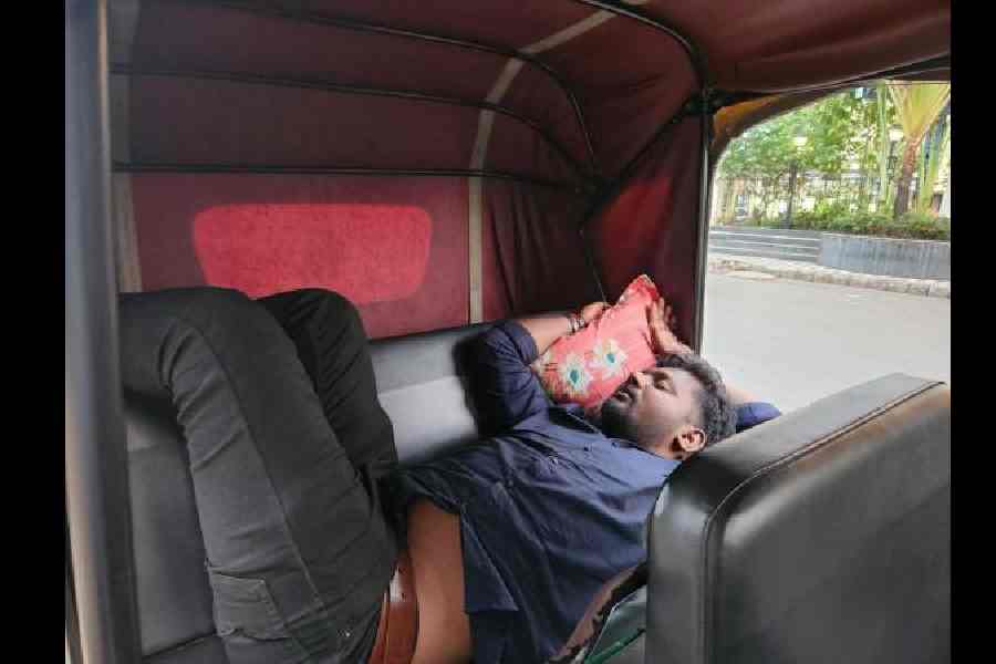 A driver sleeps in his auto, waiting for gas outside the City Centre petrol pump on Monday afternoon.