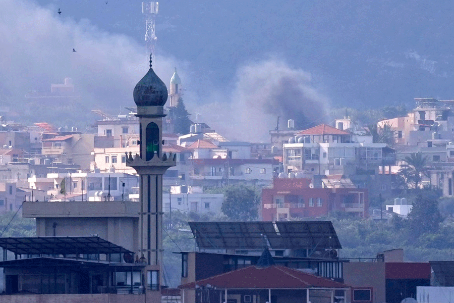 Some rising from an Israeli airstrike that hit Qlaileh village, is seen from Tyre city, south Lebanon, Friday, March 27, 2026.