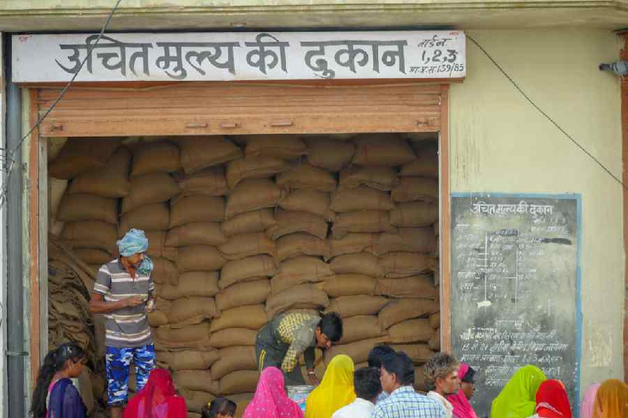 People gather outside Indian government ration store.
