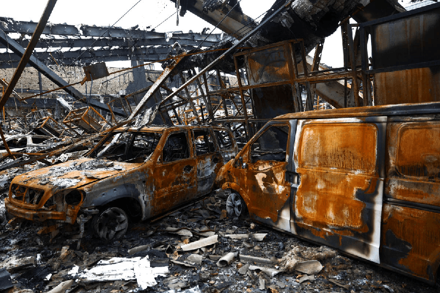 Burnt-out vehicles at the site of a car repair shop and dealership damaged by a strike, amid the U.S.-Israeli conflict with Iran, in Tehran, Iran, March 28, 2026.