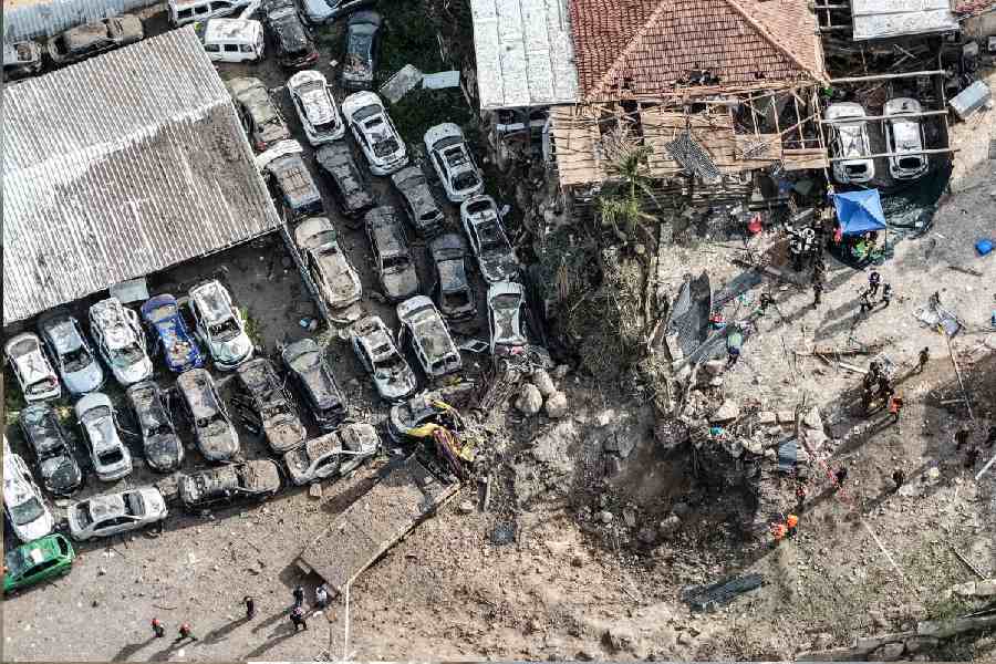 Israeli security and rescue personnel working at the impact site following Iranian missile barrages
