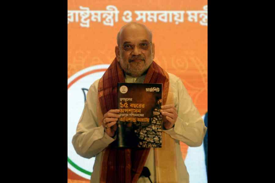 Amit Shah holds up the ‘chargesheet’ against the Trinamool Congress government in Calcuttaon Saturday