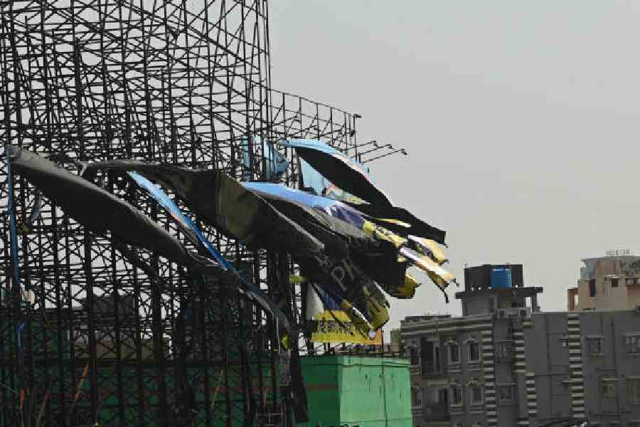 Torn advertisement flexes and (right) bent hoardings in Tangra on Saturday, after Friday night’s storm. Pictures by Bishwarup Dutta
