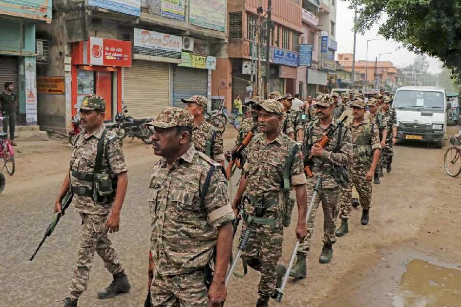 Paramilitary personnel conduct a route march ahead of the announcement of West Bengal Assembly election dates by the Election Commission, in Bolpur, Birbhum district of West Bengal.
