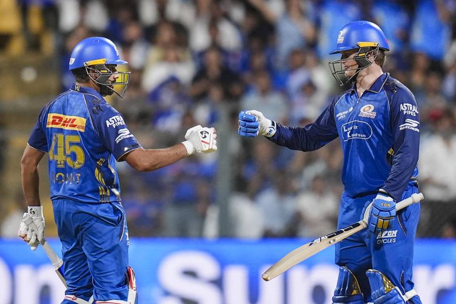 Mumbai Indians' Rohit Sharma, left, and Ryan Rickelton greet each other between the wickets during an Indian Premier League (IPL) 2026 T20 cricket match between Mumbai Indians and Kolkata Knight Riders, at the Wankhede Stadium, in Mumbai, Maharashtra, Sunday, March 29, 2026.