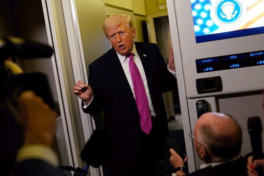 U.S. President Donald Trump talks to members of the media aboard Air Force One en route to Joint Base Andrews, Maryland, U.S., March 29, 2026.