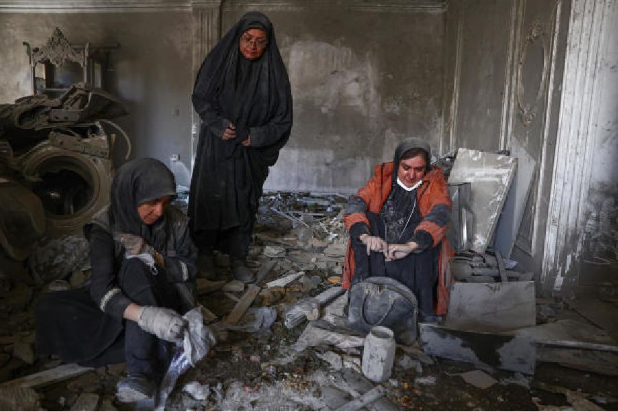 Women at a strike-ravaged home in Tehran on Monday. (Majid Asgaripour/West Asia News Agency via Reuters)