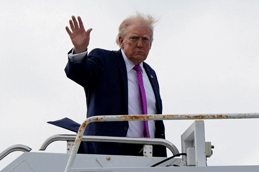 FILE PHOTO: U.S. President Donald Trump waves as he boards Air Force One at Palm Beach International Airport in West Palm Beach, Florida, U.S., March 29, 2026.
