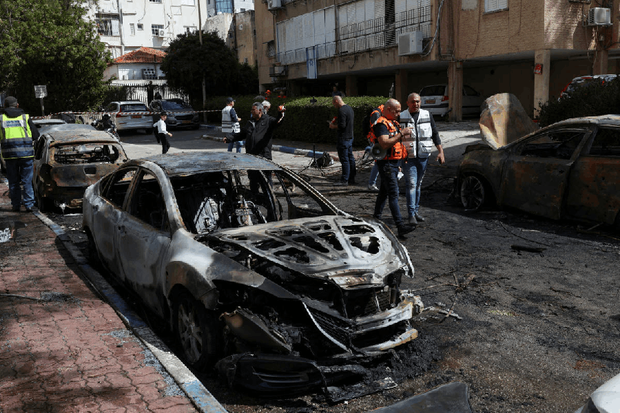 Emergency personnel work at the site where damage was caused following the launch of barrages of Iranian missiles towards Israel, amid the U.S.-Israeli conflict with Iran, in Petach Tikva, Israel, March 31, 2026.