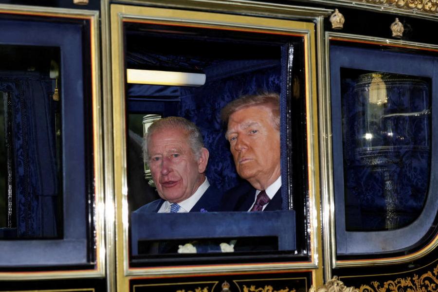 Britain's King Charles and US President Donald Trump sit in a carriage during a procession through Windsor Castle, in Windsor, Britain, September 17, 2025.