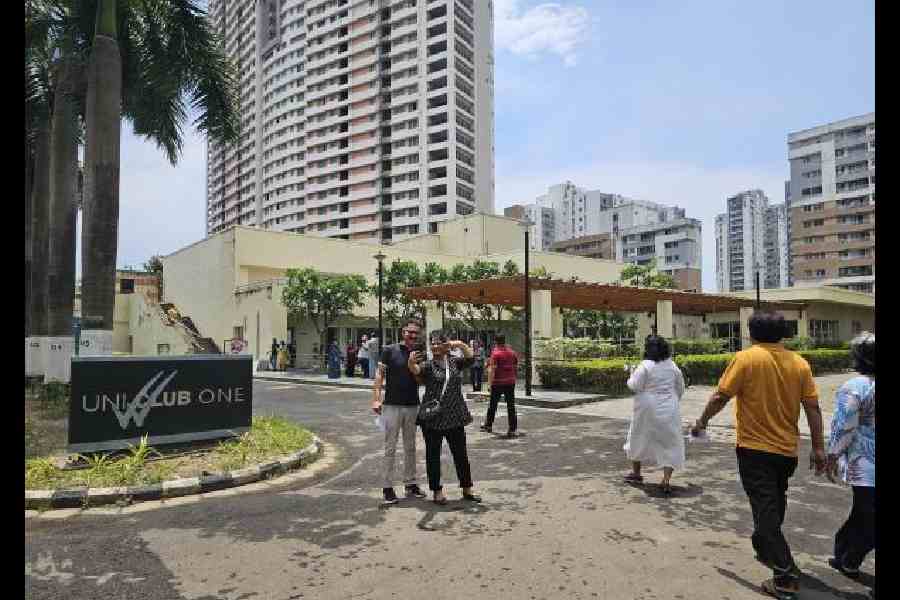 A couple takes a selfie in front of Uni Club at Uniworld City where a polling booth has been set up for the first time