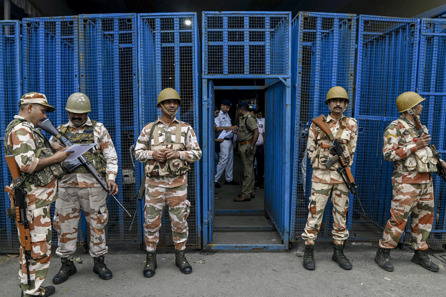 Security personnel stand guard outside a strong room at Khudiram Anushilan Kendra, ahead of the counting of votes for the West Bengal Assembly elections, in Kolkata, West Bengal, Friday, May 1, 2026.