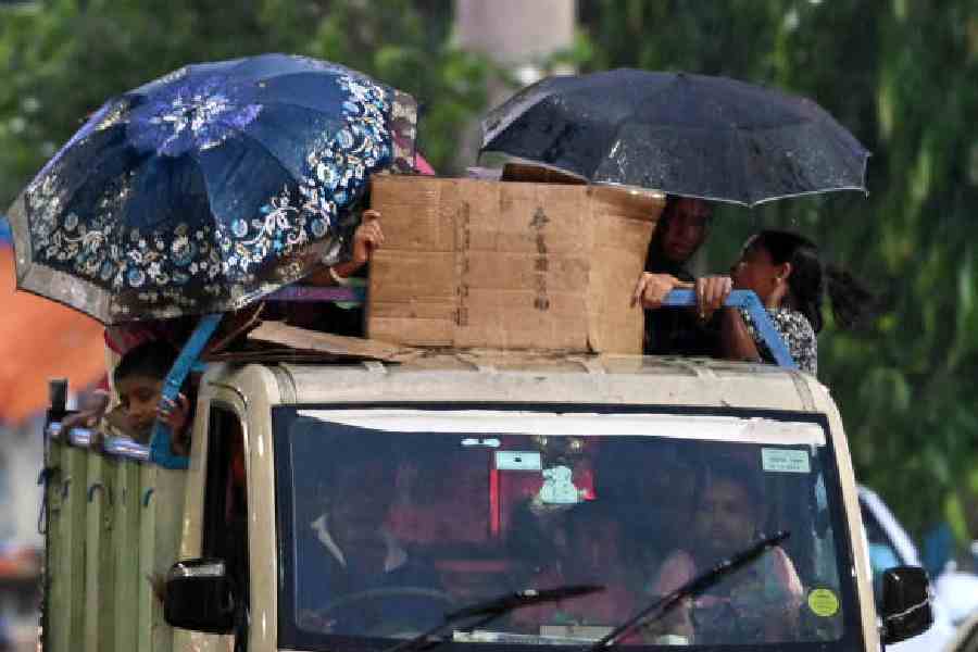 Passengers on a van caught in the rain on JL Nehru Road