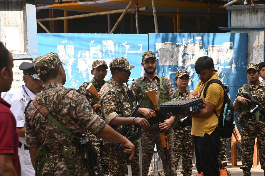 Security personnel on Sunday stand guard outside Sakhawat Memorial Government Girls’ High School,which houses the strongroom of the Bhabanipur constituency.