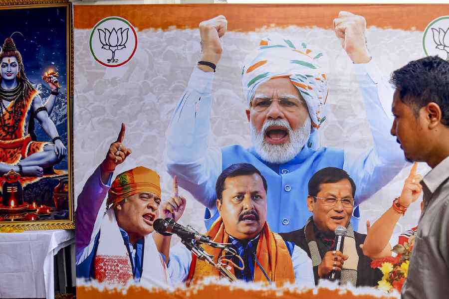 A man passes by a huge hoarding of BJP during the Assam Assembly elections result day, in Guwahati, Monday, May 4, 2026.