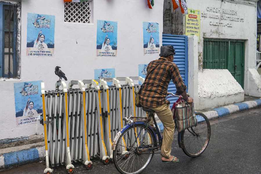 A man on his bicycle rides past near outgoing West Bengal Chief Minister Mamata Banerjee's residence as security has been scaled down following her defeat in the state Assembly elections, at Kalighat area, in Kolkata, Wednesday, May 6, 2026.