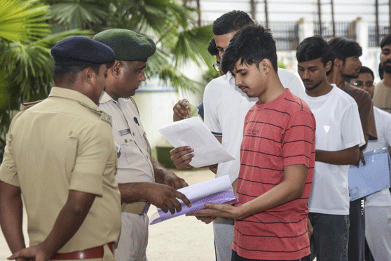 Police personnel check aspirants before the National Eligibility-cum-Entrance Test (NEET) UG-2026 examination, in Patna, Bihar, Sunday, May 3, 2026.
