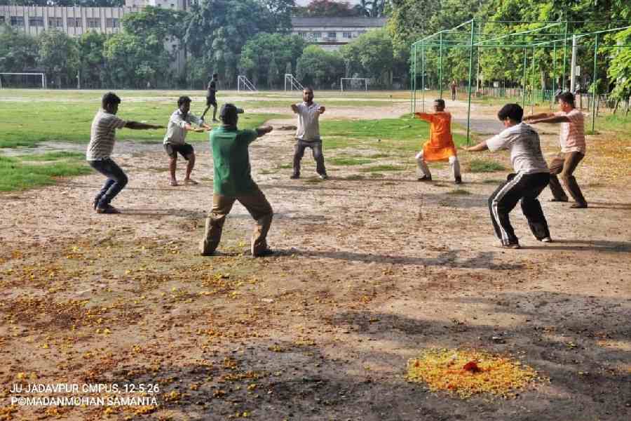 A group of JU employees performs drills at the RSS shakha on the football ground on the campus on Tuesday morning