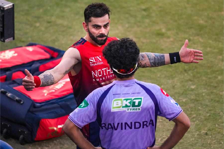 Royal Challengers Bengaluru's Virat Kohli with Kolkata Knight Riders' Rachin Ravindra