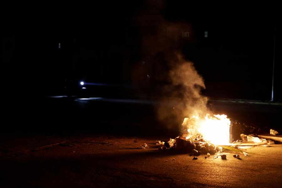 Trash set on fire in the middle of a street 