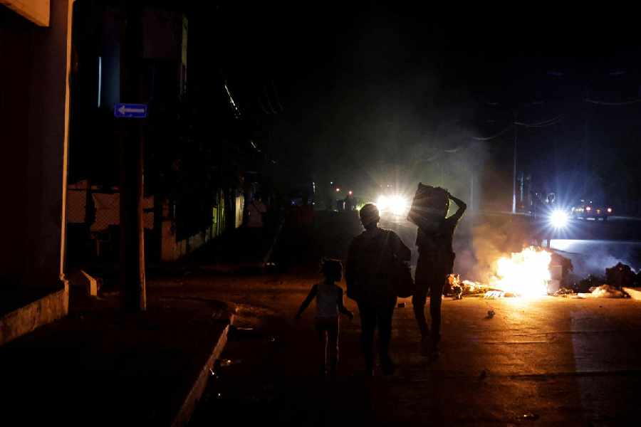 People walk past trash set on fire