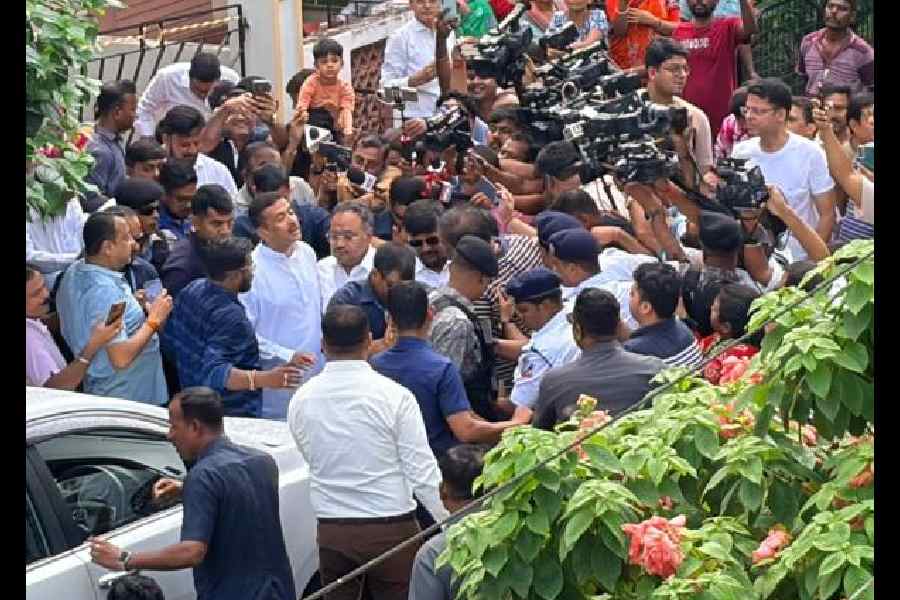 Suvendu Adhikari and Samik Bhattacharya outside the latter’s BH Block house on Monday